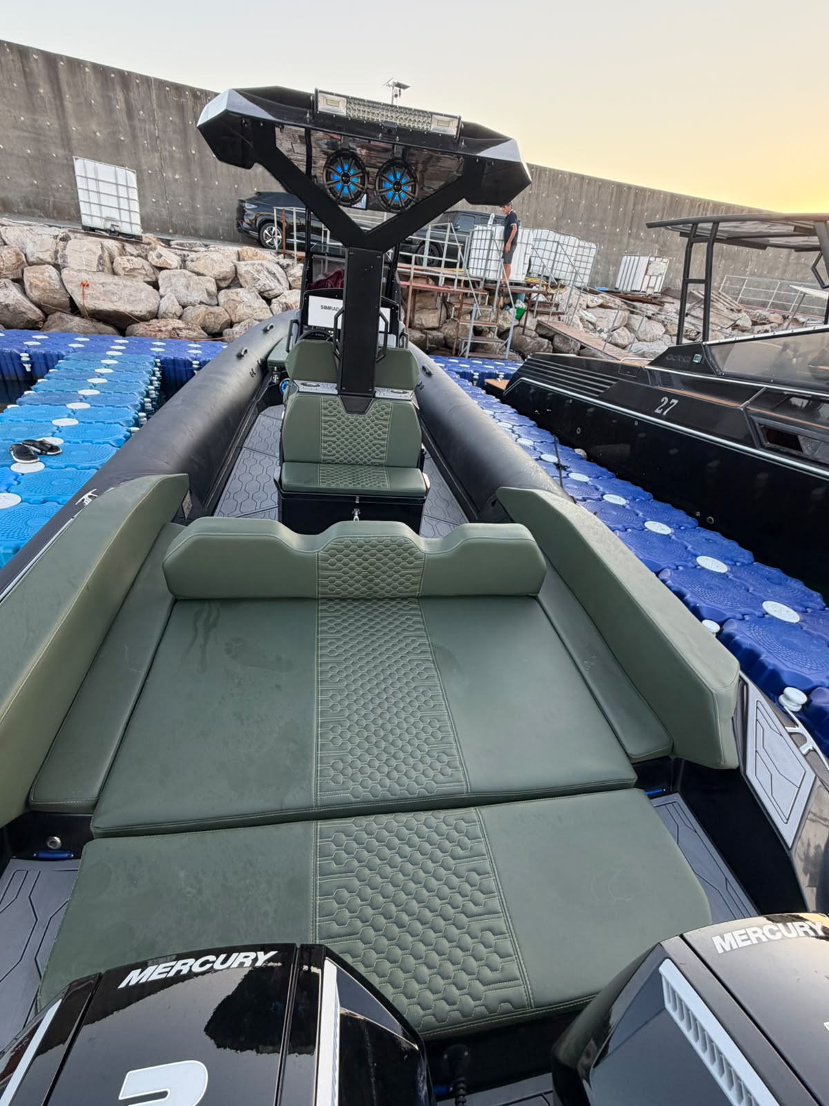 Aft sunbed in green quilted upholstery, looking toward the T-top