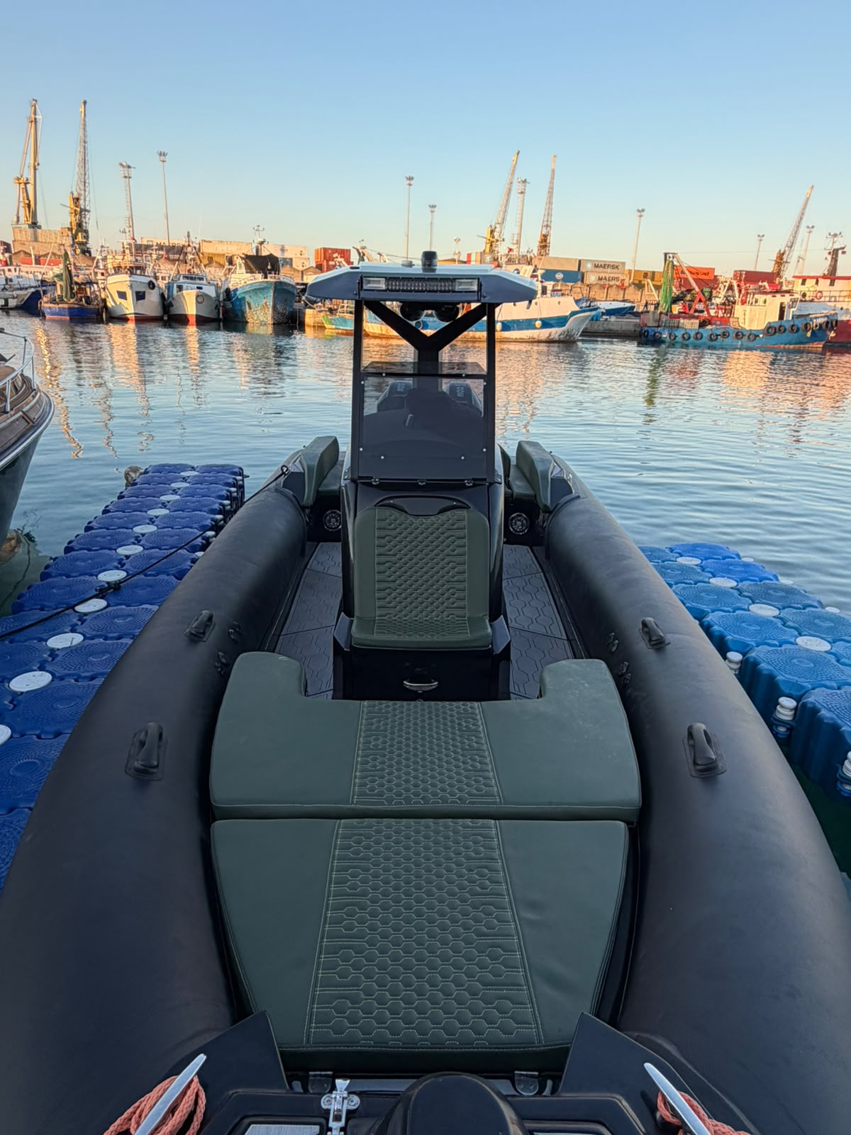 RIB 9.5 seen from the stern in the harbor at sunset