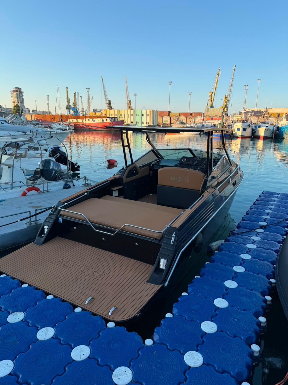 Gobbi 27 stern view at the dock, golden hour
