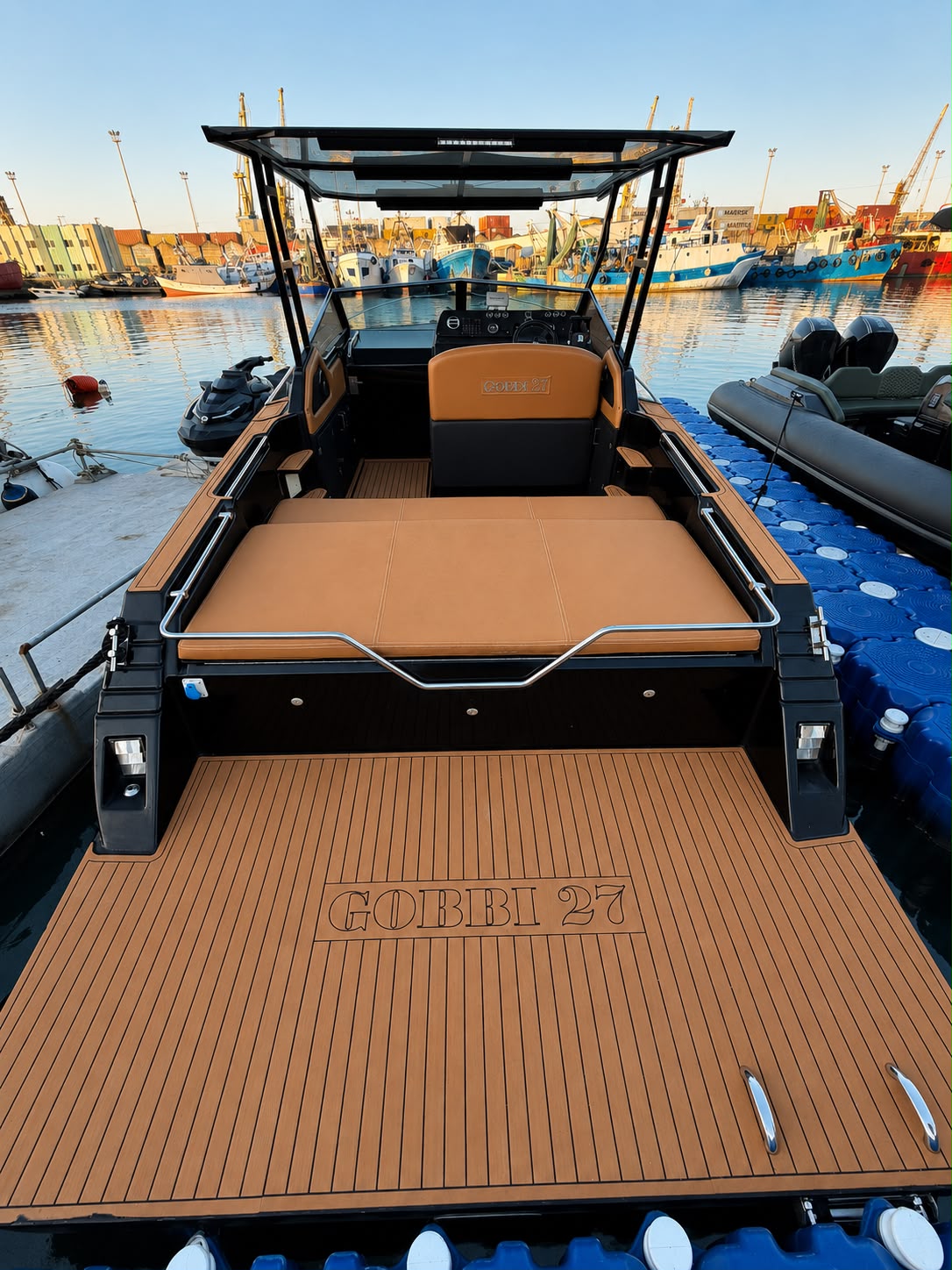 Large tan leather sunbed and teak swim platform
